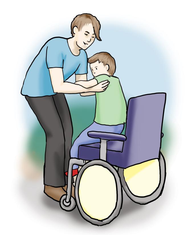 Eine Person hebt ein Kind aus dem Rollstuhl